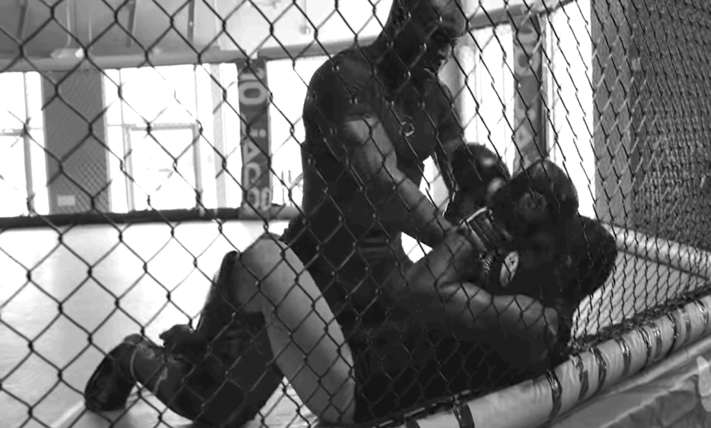 MMA fighters sparring in cage